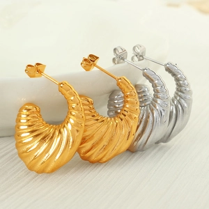 Vintage style gold and silver croissant earrings with chunky spiral textured design