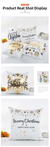 Close-up of modern Christmas cushion cover with gold Merry Christmas foil lettering