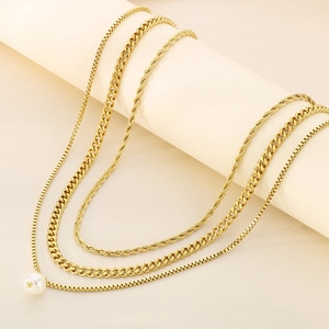 Golden layered necklace set with white pearl pendant, Cuban link, and rope chain styles
