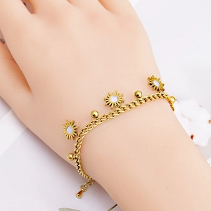 Chic gold stainless steel bracelet with sunflower shell charms on a female wrist