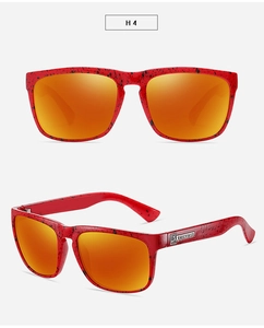 Detail view of red frame sports sunglasses with black speckled pattern and orange lenses