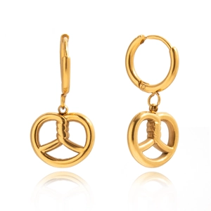 Macro shot of gold pretzel-shaped dangle earrings with matte metallic texture