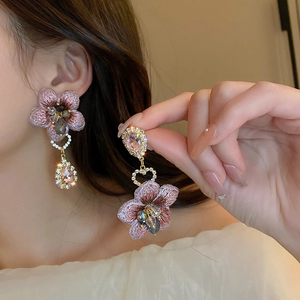 Pink fabric flower earrings with rhinestone teardrop crystals in an asymmetric design
