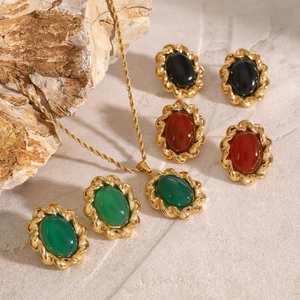 Retro stainless steel jewelry set featuring oval red agate and twisted gold earrings
