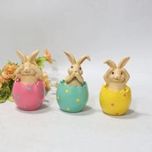 Three-piece bunny figurines in colorful polka dot eggshells with hear, see, speak no evil poses