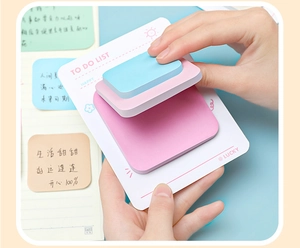 Macro detail of multi-layered To-Do List sticky notes in pink and blue Morandi colors