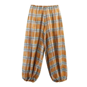 Detailed view of orange and blue plaid harem pants with cotton linen texture