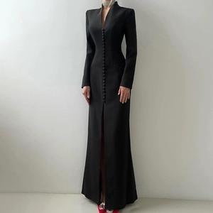 Detail of elegant black V-neck dress featuring front buttons and a high slit design