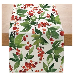 Detail of floral Christmas table runner showing watercolor berries and leaves on beige fabric