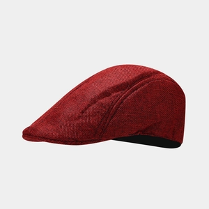 Macro shot of dark red breathable fabric and stitching details on the retro flat cap