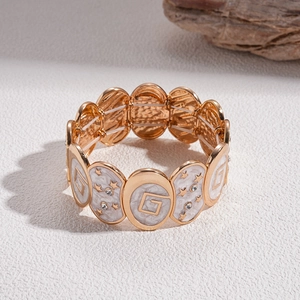 Close-up of gold star pattern enamel bracelet with high elastic band and tiny rhinestones