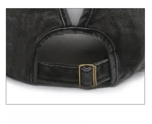 Detail of adjustable metal buckle on washed black denim baseball cap with ponytail hole