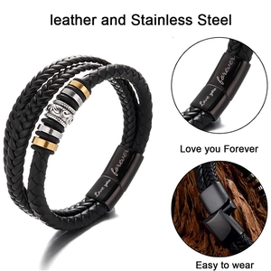 Detail of multi-layer braided leather bracelet with engraved magnetic stainless steel clasp