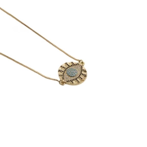 Golden box chain necklace featuring a round blue evil eye pendant with clear crystals