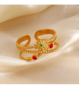 Golden sunburst layered open ring with red and green enamel on champagne silk fabric