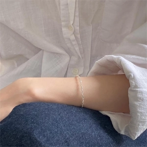 Minimalist 925 sterling silver beaded bracelet worn with casual outfit on wrist