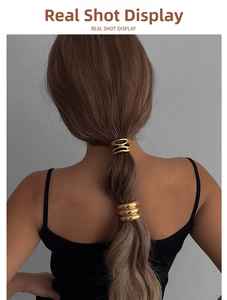 Polished gold geometric alloy hair tie set showing a multi-layer design on a ponytail