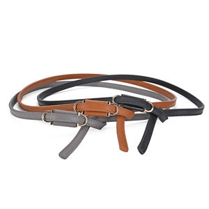 Three minimalist slim PU leather belts for women in black, brown and grey with gold round buckles