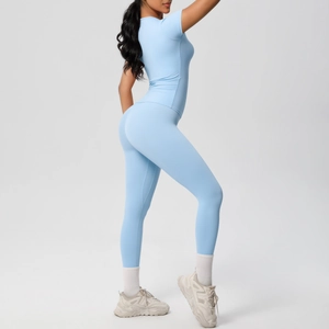 Full-body shot of a light blue seamless yoga set with short sleeves and high-waist leggings