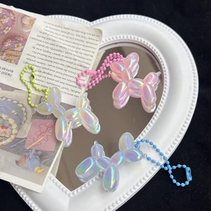 Three cute colorful laser balloon dog keychain charms in pink, white and blue colors