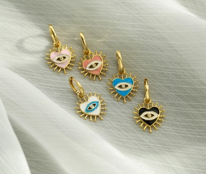 Five pairs of colorful heart evil eye drop earrings in pink blue black white and gold