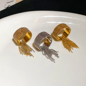 Detail of beaded tassel rings in gold and silver finish on a ceramic tray