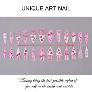 Detail of almond press-on nails featuring red lip prints, bows and heart crystal designs