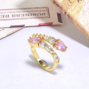 Golden snake-shaped open ring with pink teardrop crystals and clear zircon accents