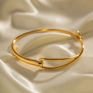 Détail d'un bracelet jonc en acier inoxydable doré 18 carats avec fermoir boucle