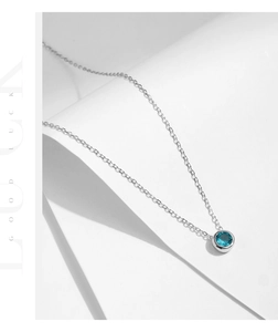 Detail view of S925 silver necklace with blue zircon pendant and Good Luck text