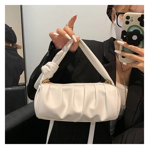 Ruched cloud shoulder bag with knotted handle detail shown in a mirror selfie
