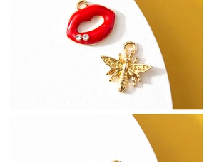 Macro view of crystal lip and 3D golden bee metal alloy pendants with intricate details