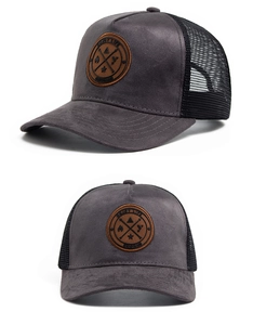 Detail of grey faux suede baseball cap with black mesh back and Enjoy Life leather patch