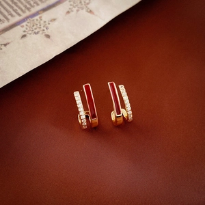 Detail of red enamel and zircon double-layer gold studs with vintage aesthetic