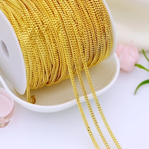 Macro shot of 18K gold plated copper Cuban chain wound on a spool for DIY jewelry