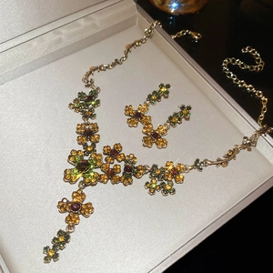 Detailed macro view of vintage flower jewelry set with colorful crystals in a gift box