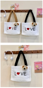 Detail of plush winter tote bags featuring Love embroidery and cute puppy charms