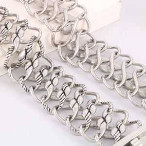 Macro detail of silver vintage braided mesh bracelet with intricate infinity link design