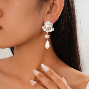 Baroque crystal earrings with pearls and floral droplets shown on a model