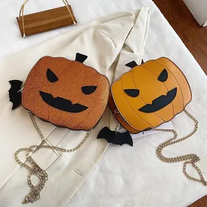 Detail showing orange glitter and plain pumpkin crossbody bags with bat charm and gold chain