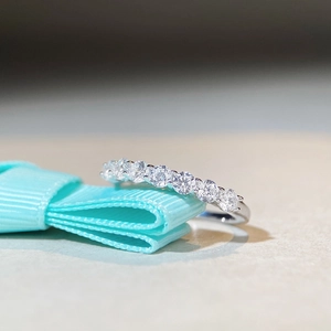 Minimalist S925 sterling silver band ring with seven sparkling zircon stones on blue ribbon