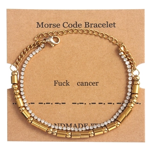 Detail of Morse Code bracelet with golden beads and rhinestones on card display