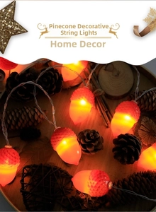 Detail view of pinecone LED string lights emitting warm glow on rustic wooden tray