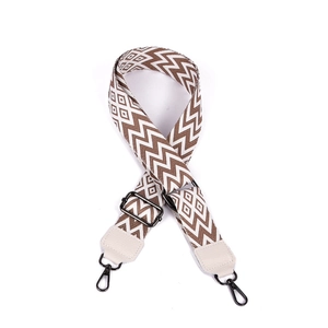Detail of 38mm ethnic geometric bag strap with brown canvas, leather ends and black hooks