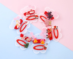 Flat lay of 6-pair Christmas hair clip set with Santa and reindeer on bear card