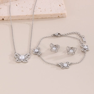 Elegant stainless steel jewelry set featuring cutout butterfly motifs and pearls