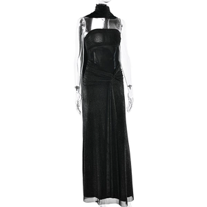 Detail view of black evening dress with shimmering fabric and waist cutout design