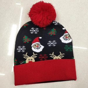 Knitted Christmas hat with Santa, reindeer, and snowflake motifs on black and red acrylic fabric