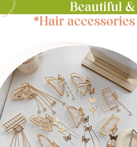 Close-up of golden metal butterfly hair claws with artificial pearls and fringe tassels