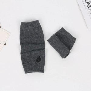 Detailed view of dark grey knitted fingerless arm warmers with thumb hole and ribbed cuffs